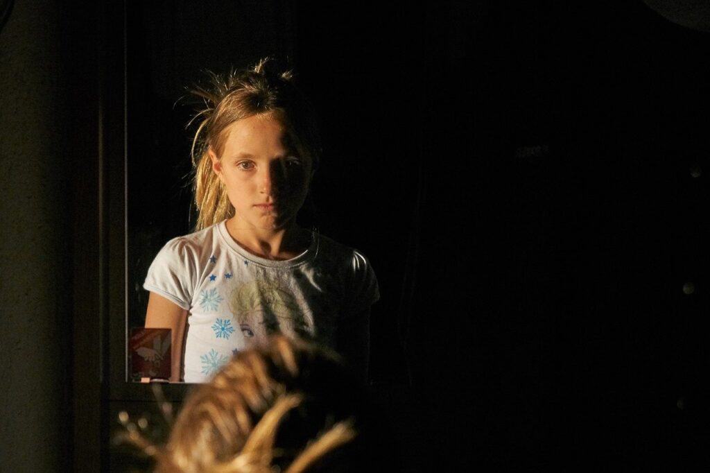 Girl unhappy looking in mirror