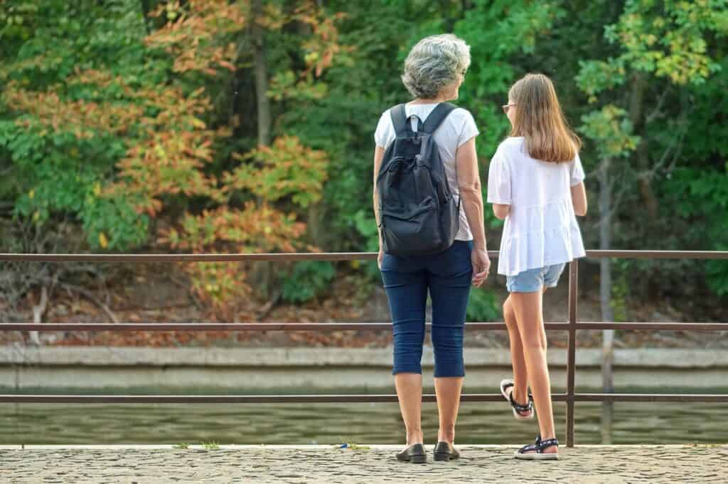 grandmother and teen looking at trees
