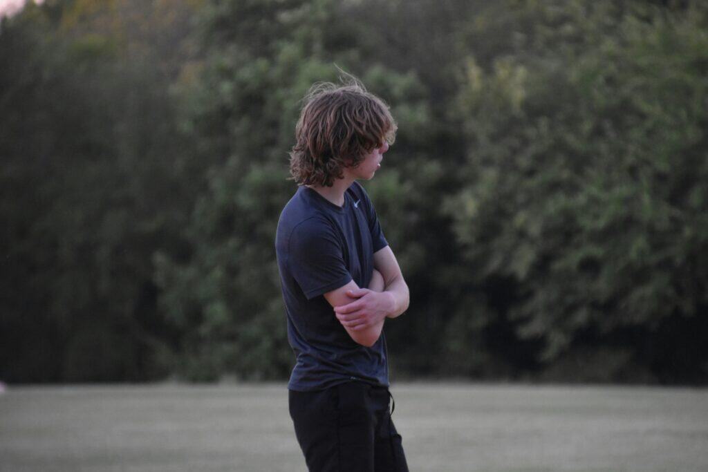 teen boy outside arms folded