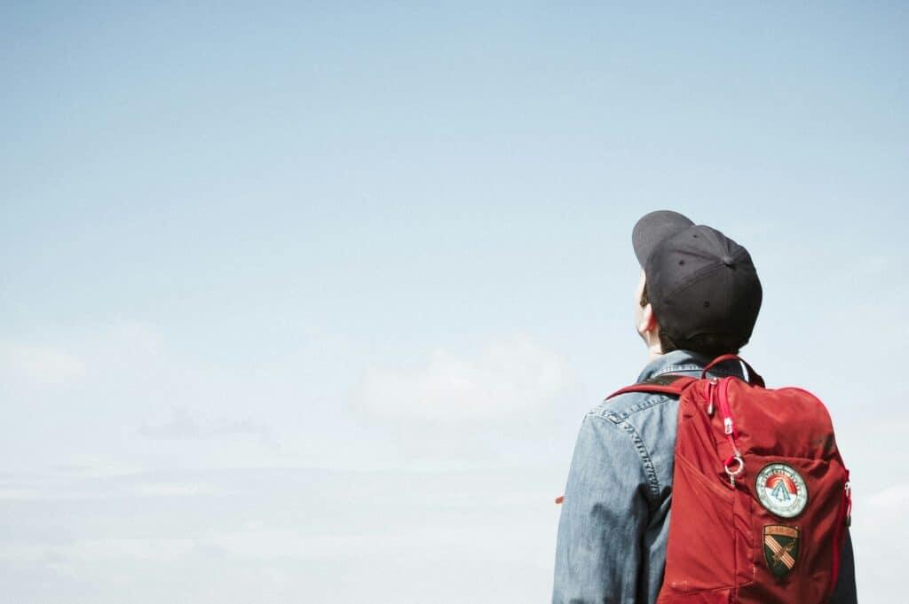 guy in baseball cap looking up at the sky