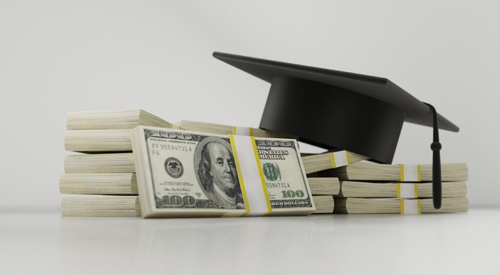graduation hat and piles of money