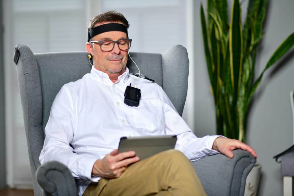 smiling older man getting biofeedback