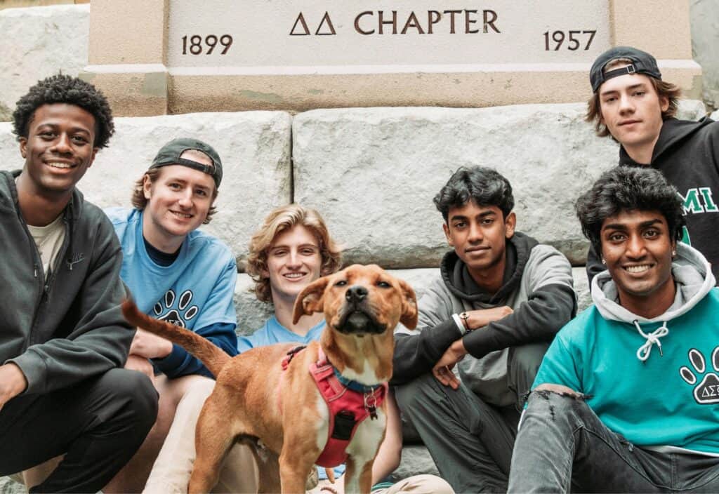 frat brothers and dog posing
