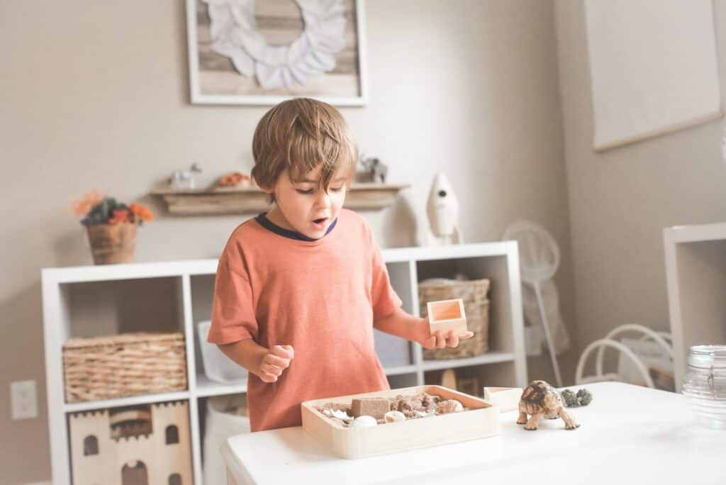 boy playing with look of wonder