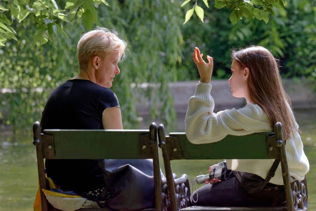 mom and daughter arguing on bench