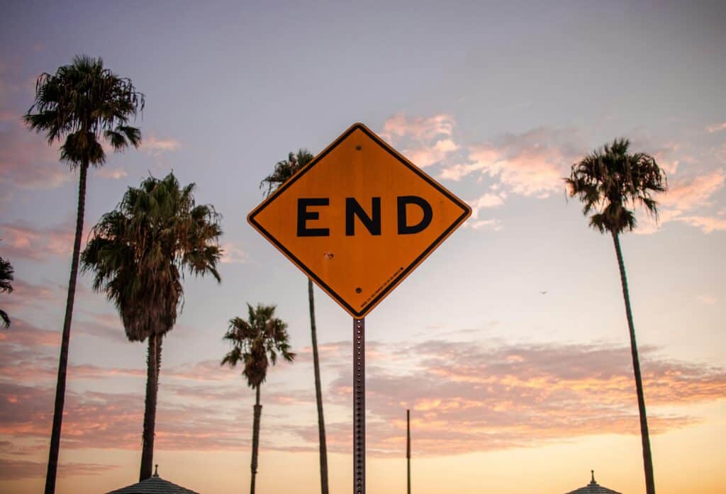 end sign palm trees sunset