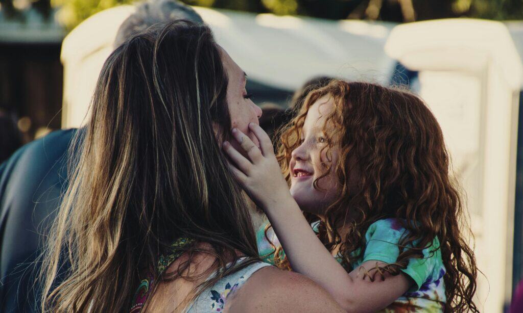 mom holding cute redheaded girl