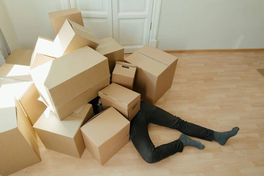 male legs sticking out under moving boxes