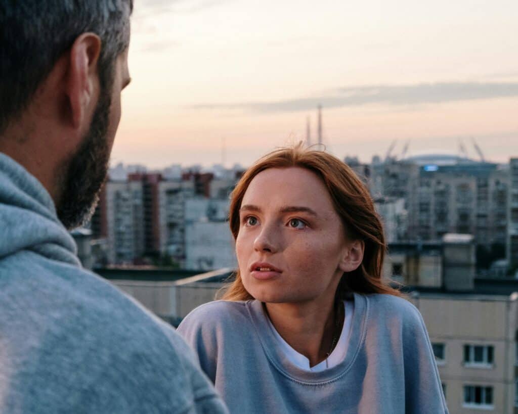 couple woman looking upset at man sunset skyline