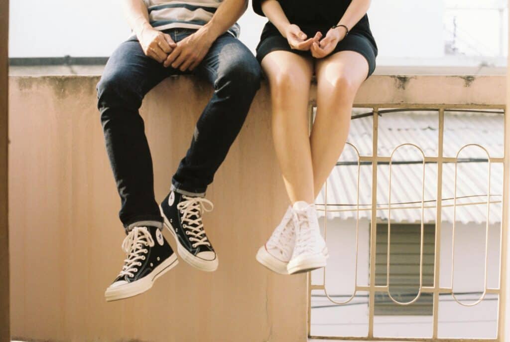 legs of man and woman sitting close