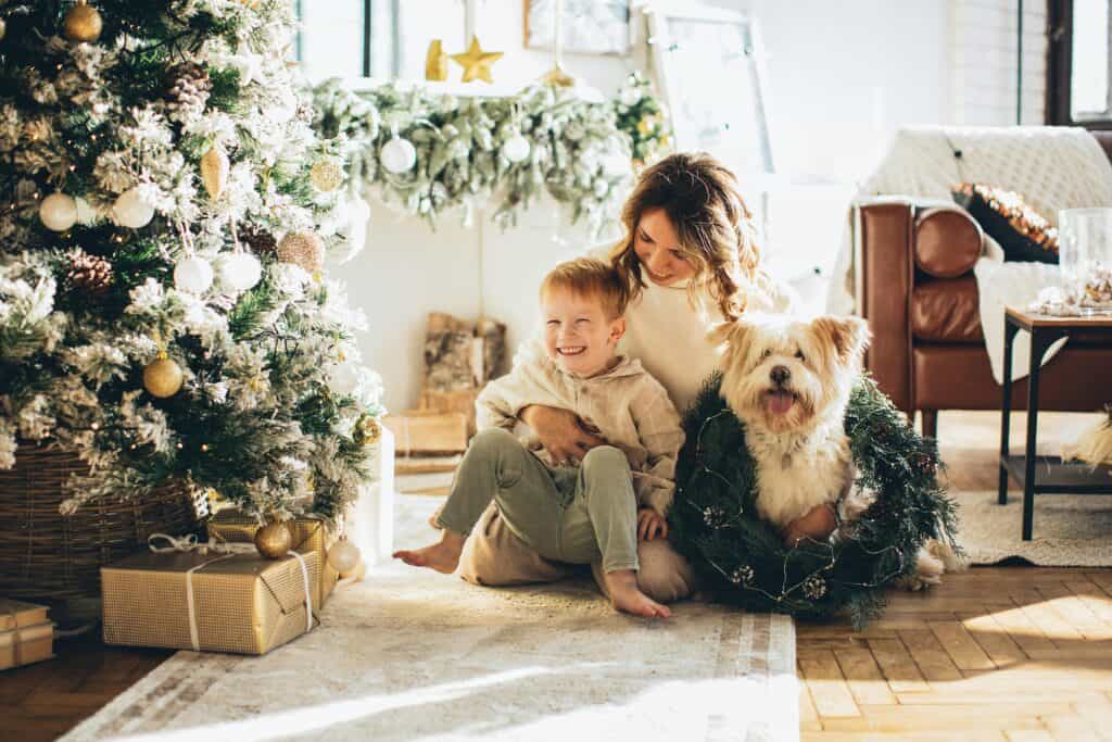mom son and dog by Christmas tree