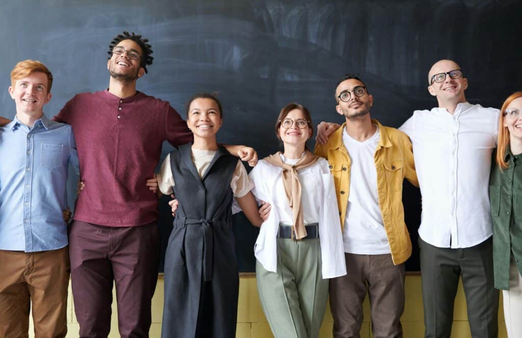 group of friends in front of chalkboard