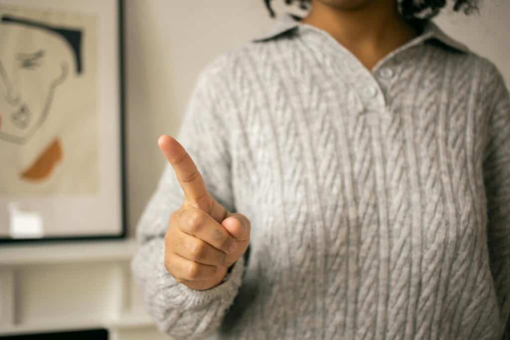 torso of woman wagging a finger no