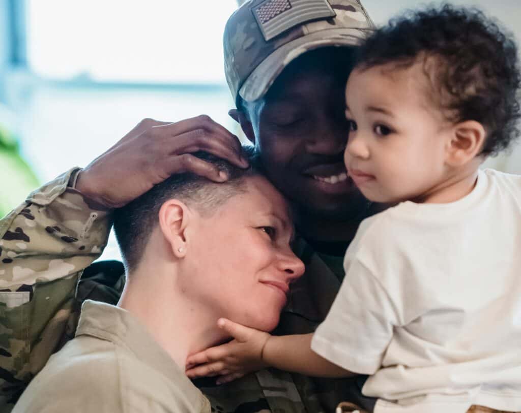 military family hugging homecoming dad child mom