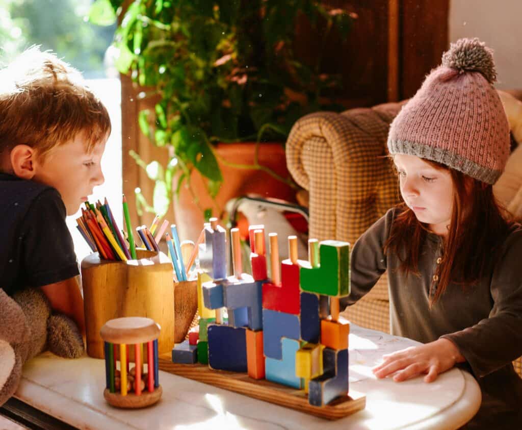 siblings playing at coffee table