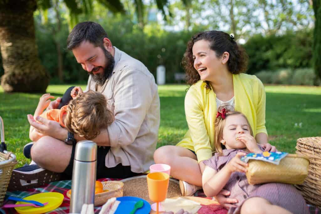 family parents and kids having a picnic fun