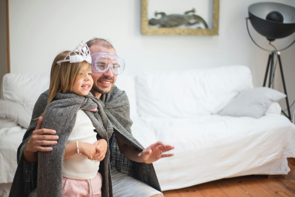 dad and daughter playing superheroes