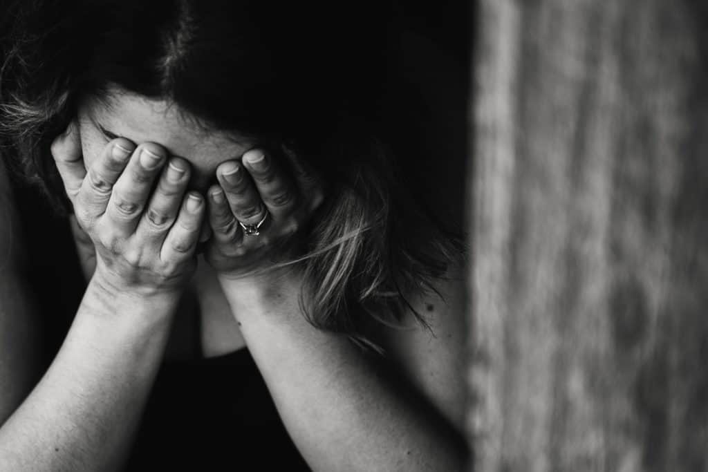 confused woman hands covering face