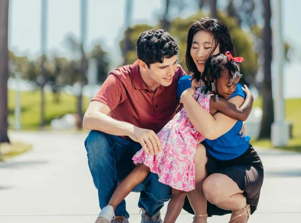 multi-racial family hugging adoption
