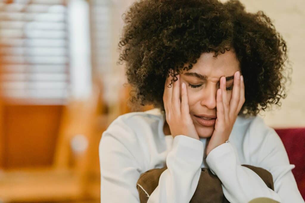 woman worried holding face in hands