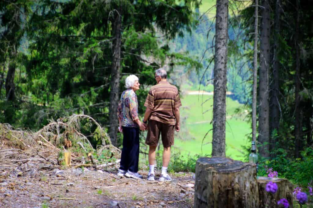 Older couple standing in forest