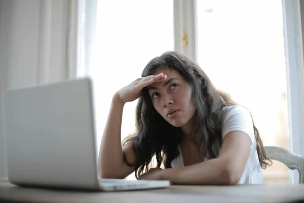 annoyed woman at computer looking up