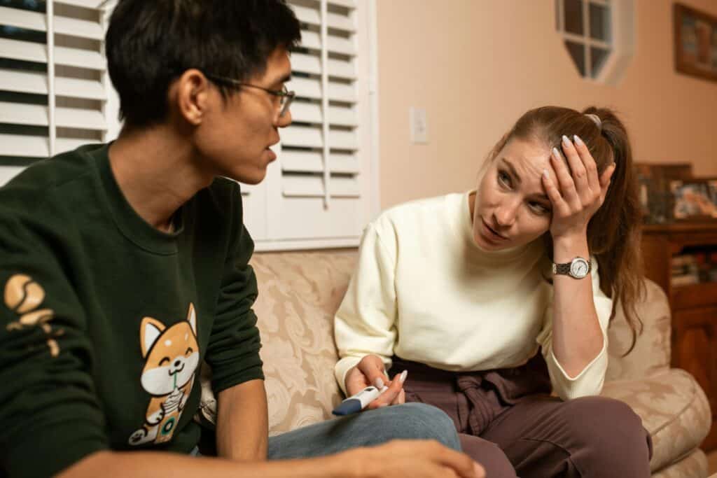 woman showing man pregnancy test
