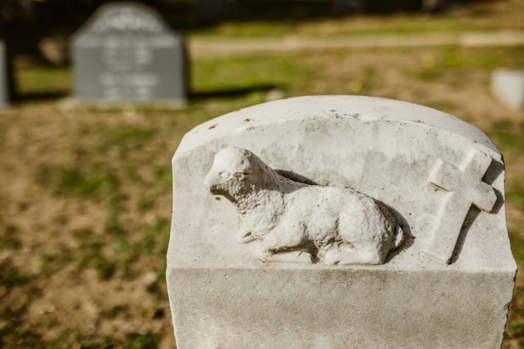 grave stone with lamb and cross