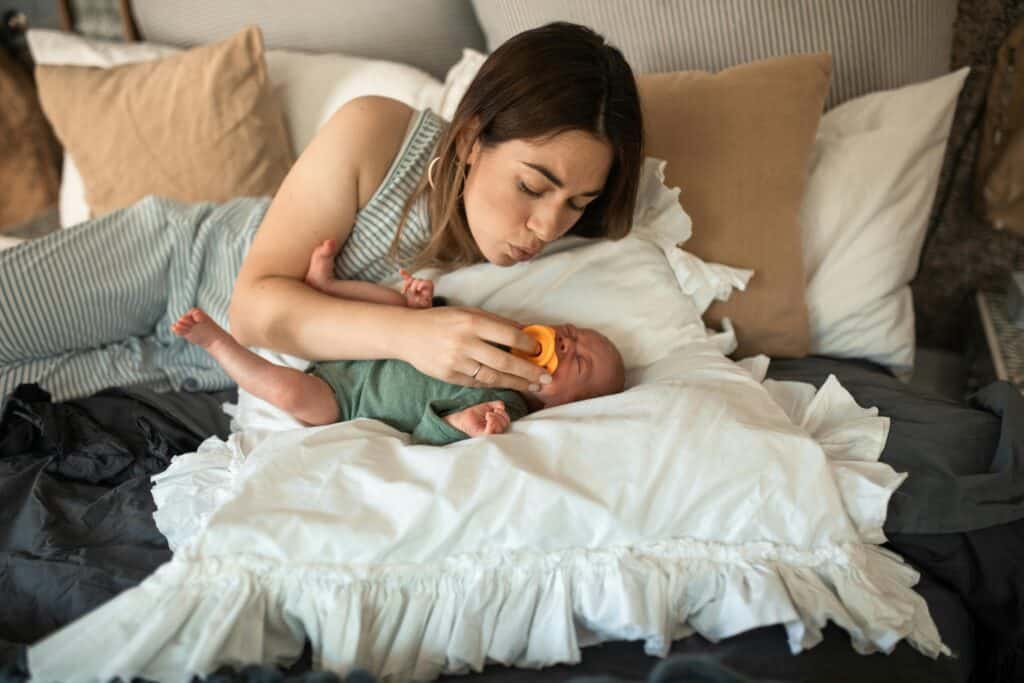 mom lying in bed with baby