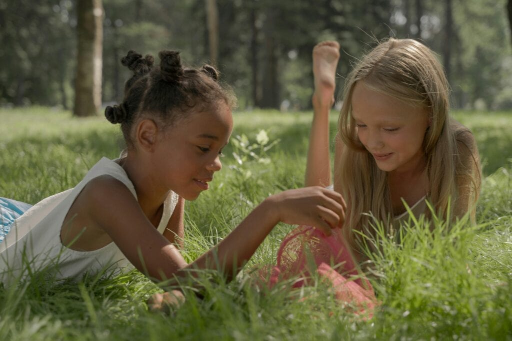 girls lying in the grass
