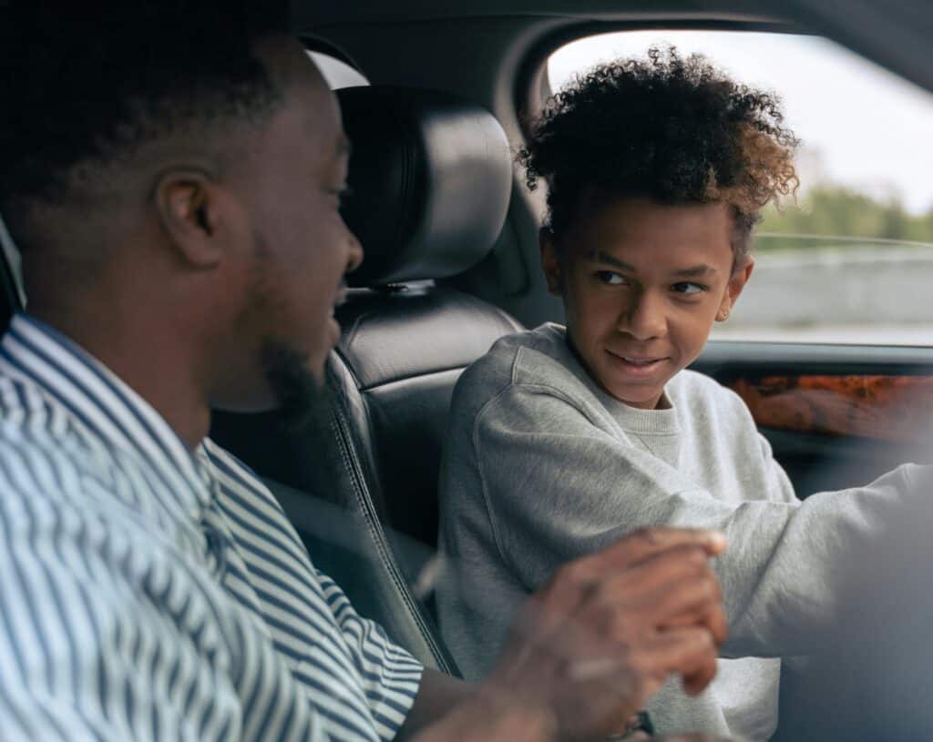 dad and teen son in car talking