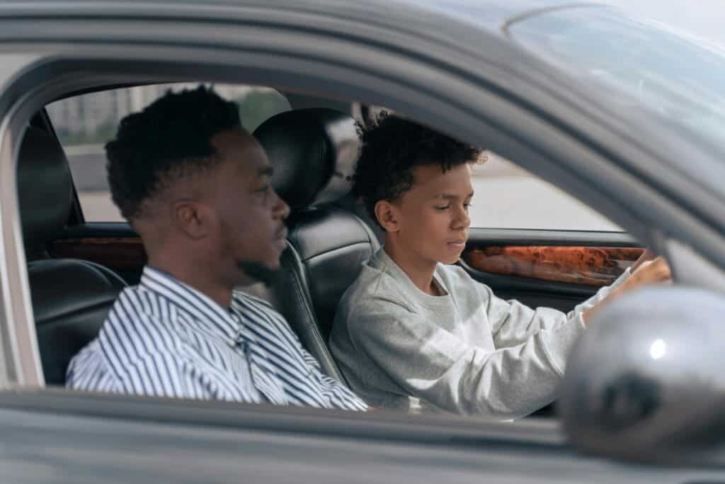 son driving dad in car