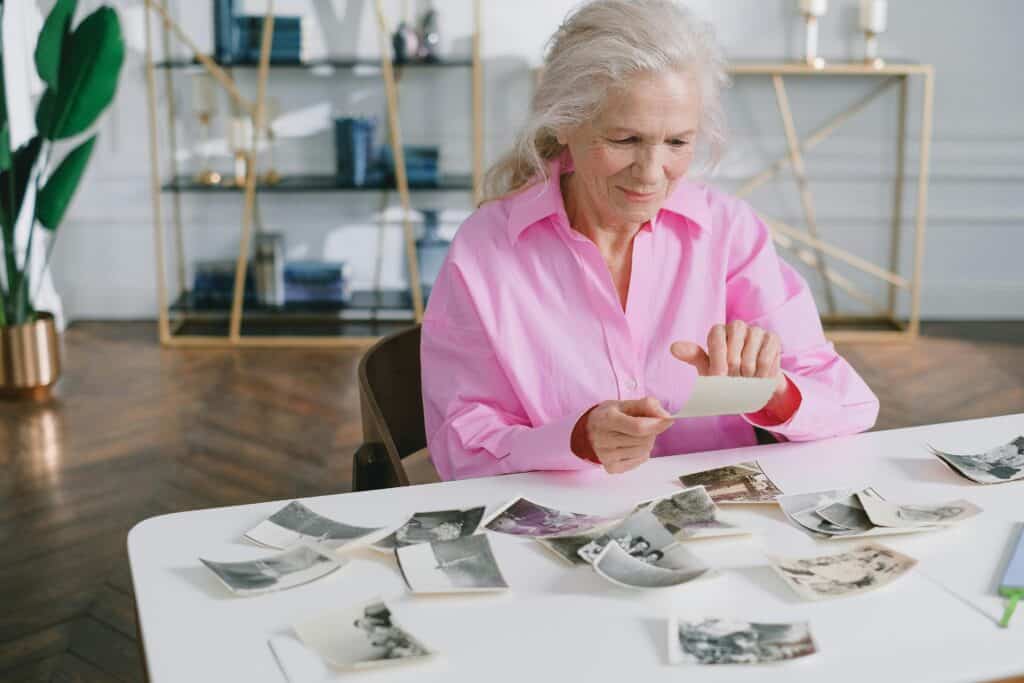 elderly woman looking at photos