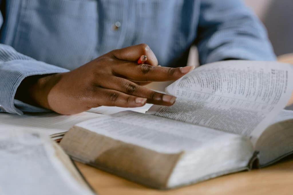 hands of person reading Bible