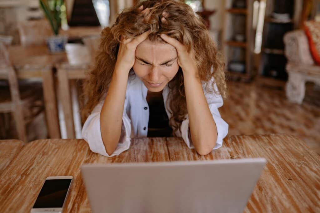 upset woman looking at computer