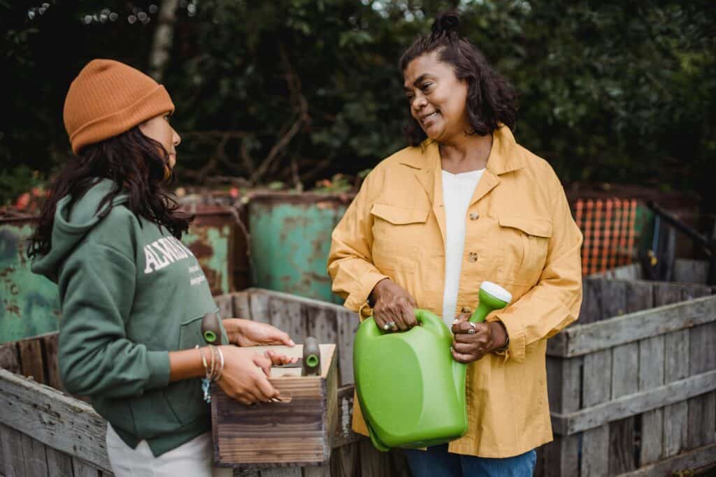 Mom and young adult daughter gardening