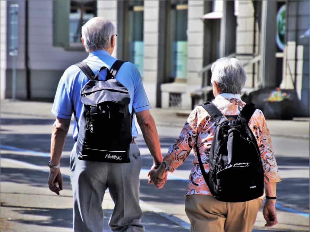 senior couple hand in hand walking