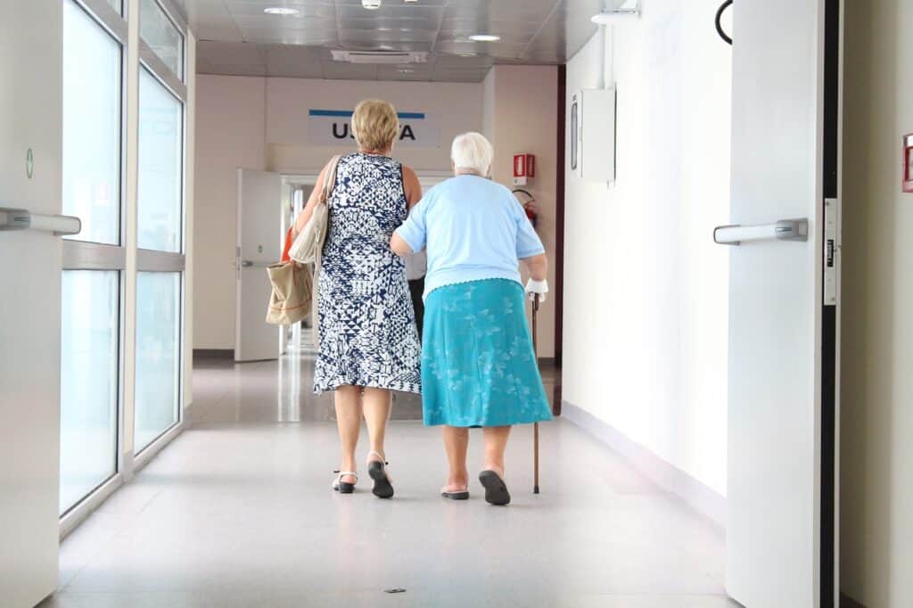 Senior women walk together through hospital