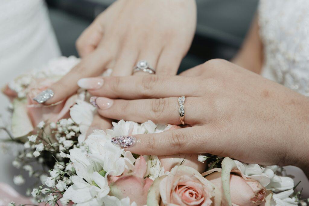 hands of two brides with rings