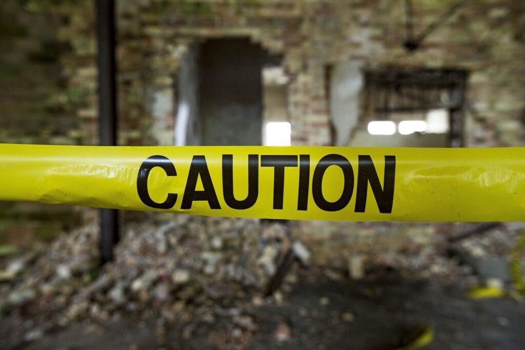 caution tape in front of spooky background