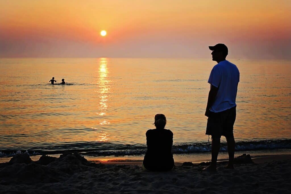 family on the beach at sunset