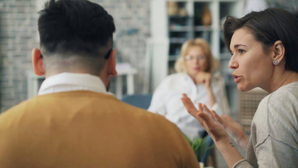 man woman and female counselor talking
