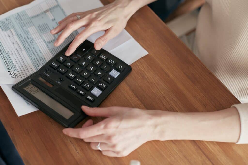 Closeup of a woman's hands using a calculator