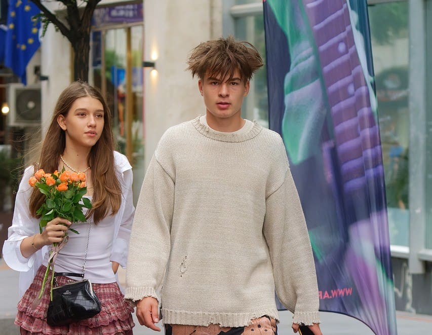 Teen couple angry guy walking down street
