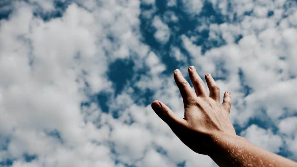 hand reaching toward heaven prayer