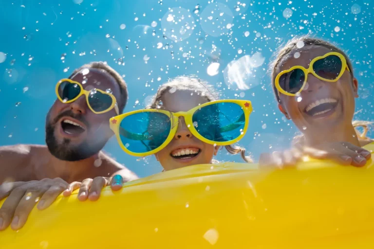 spring break fun with mom and dad, and a little girl with oversized sunglasses in the pool