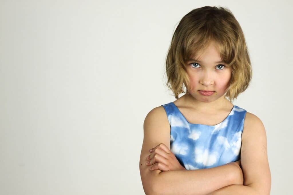unhappy girl with arms folded