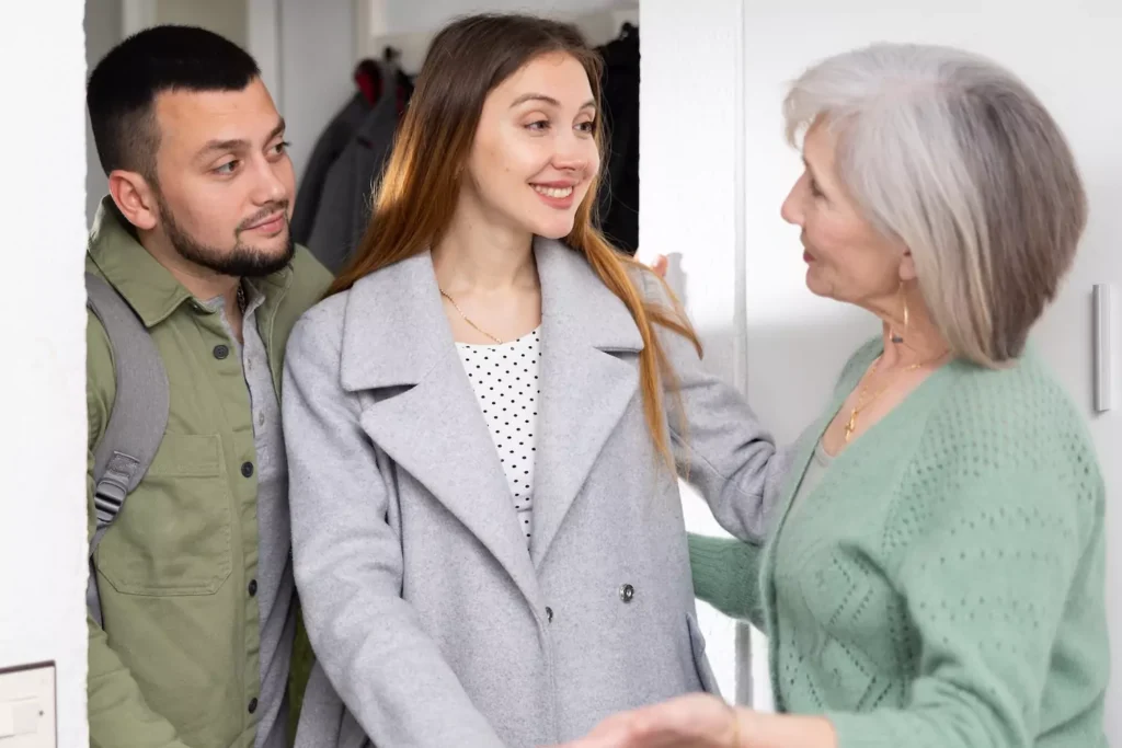 A mother-in-law welcomes her daughter and her husband into her home.