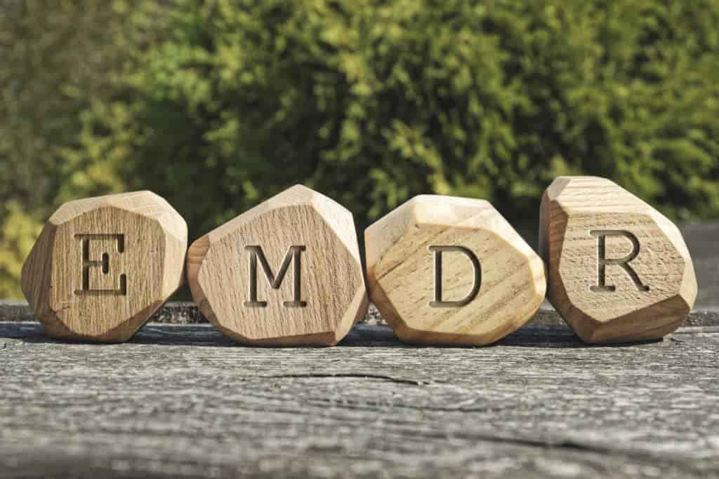 letters EMDR written on wooden blocks - Eye Movement Desensitization and Reprocessing