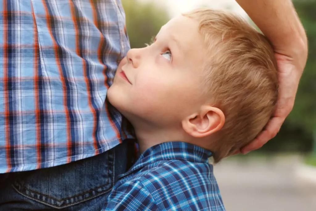 little boy looking up lovingly at his father